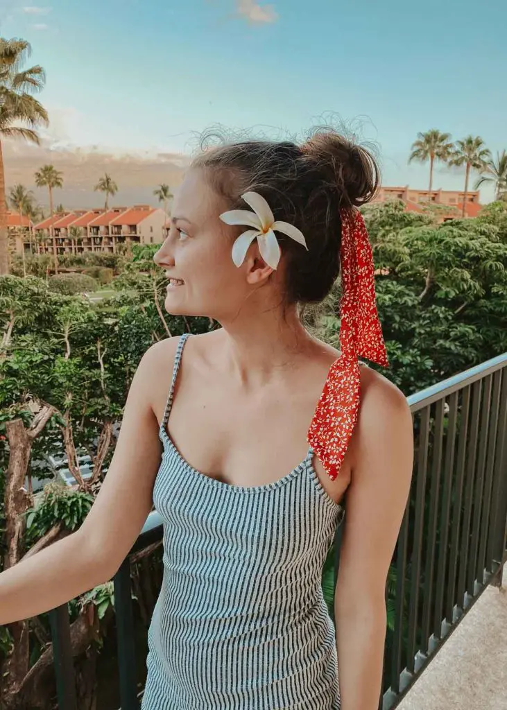 Woman wearing striped dress on a balcony in Maui