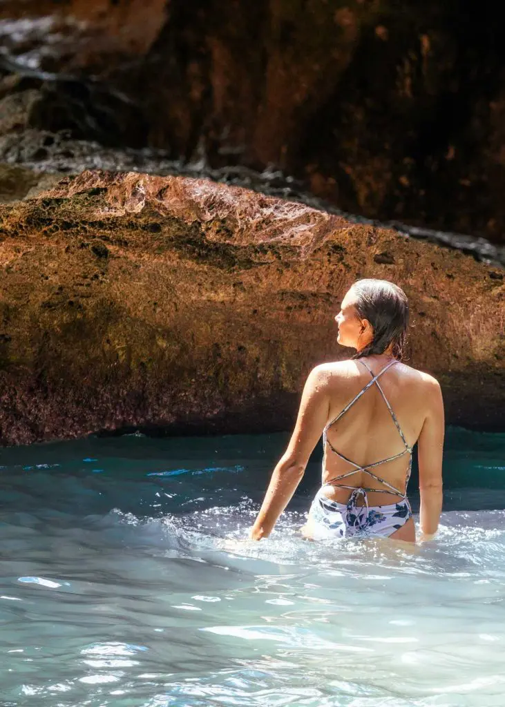 Wading in the water in the Oahu Mermaid Caves