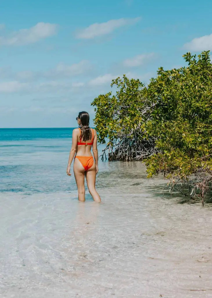woman standing in shallow water on caye caulkers north island