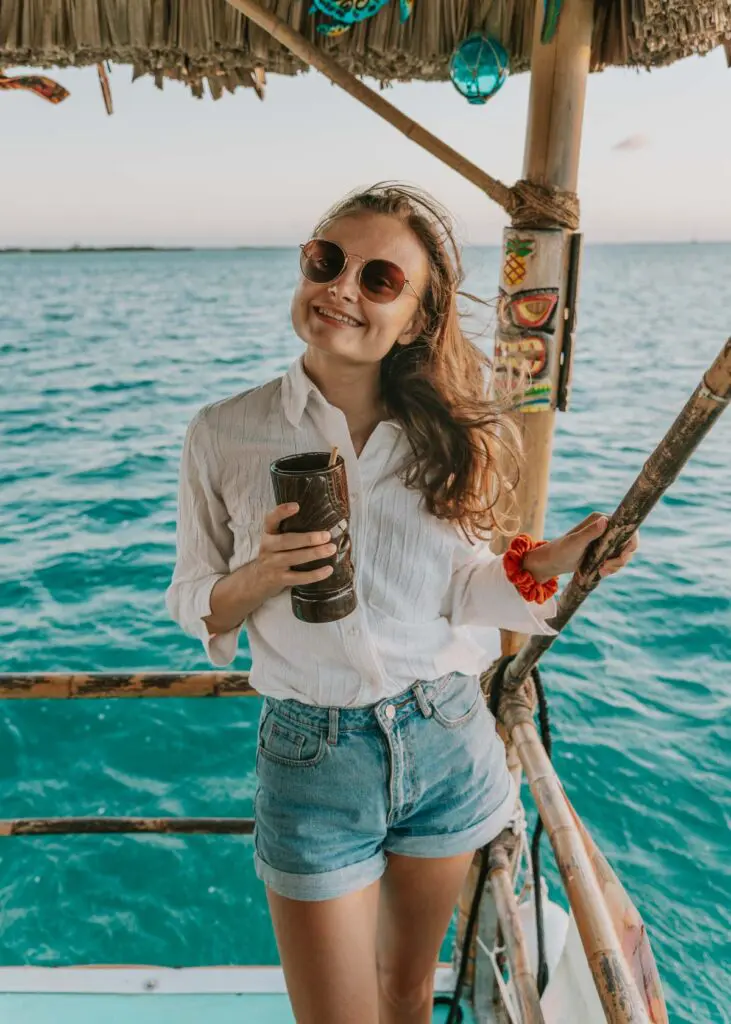Me on a tiki sunset cruise in Belize, one of the Viator tours I went on before writing this Viator review