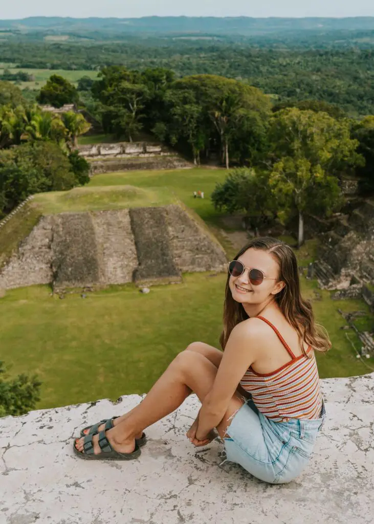 woman sitting at the top of Mayan temple in Belize