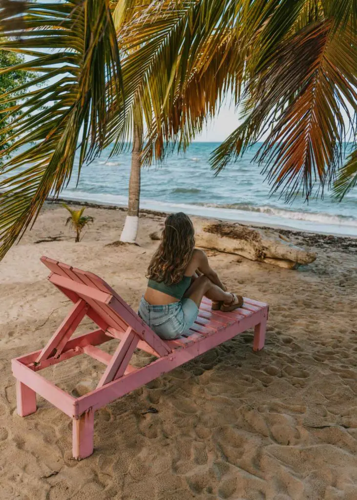 sitting by the water in hopkins belize, the first stop on this 10 day belize itinerary