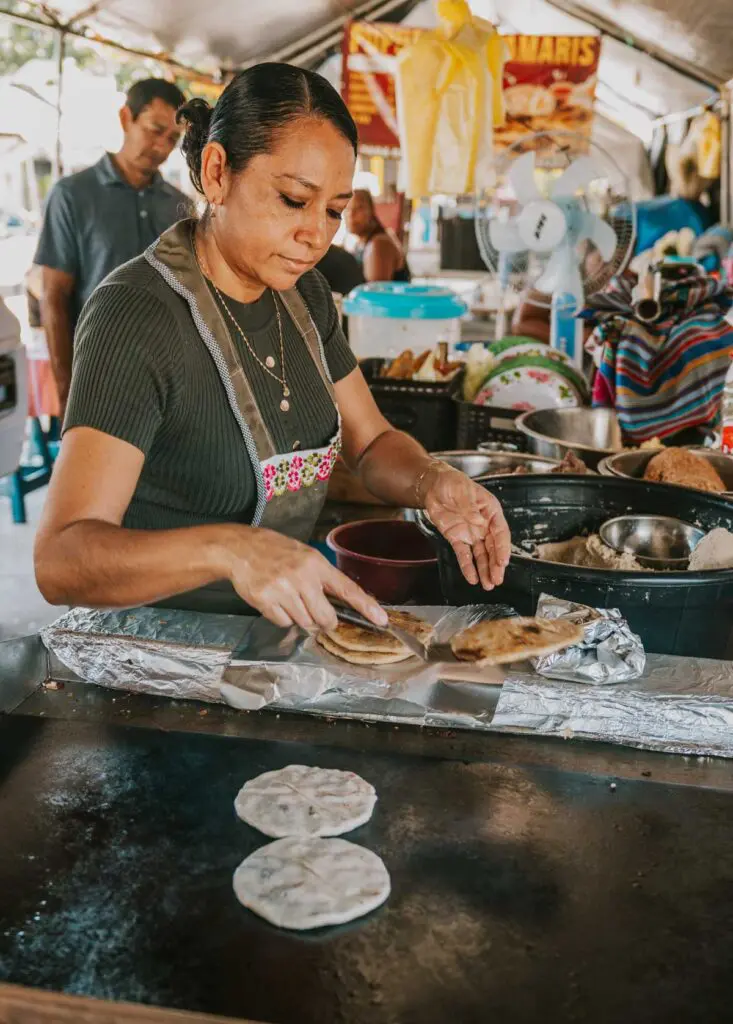 Woman making papusas at San Ignacio Market in San Ignacio, Belize