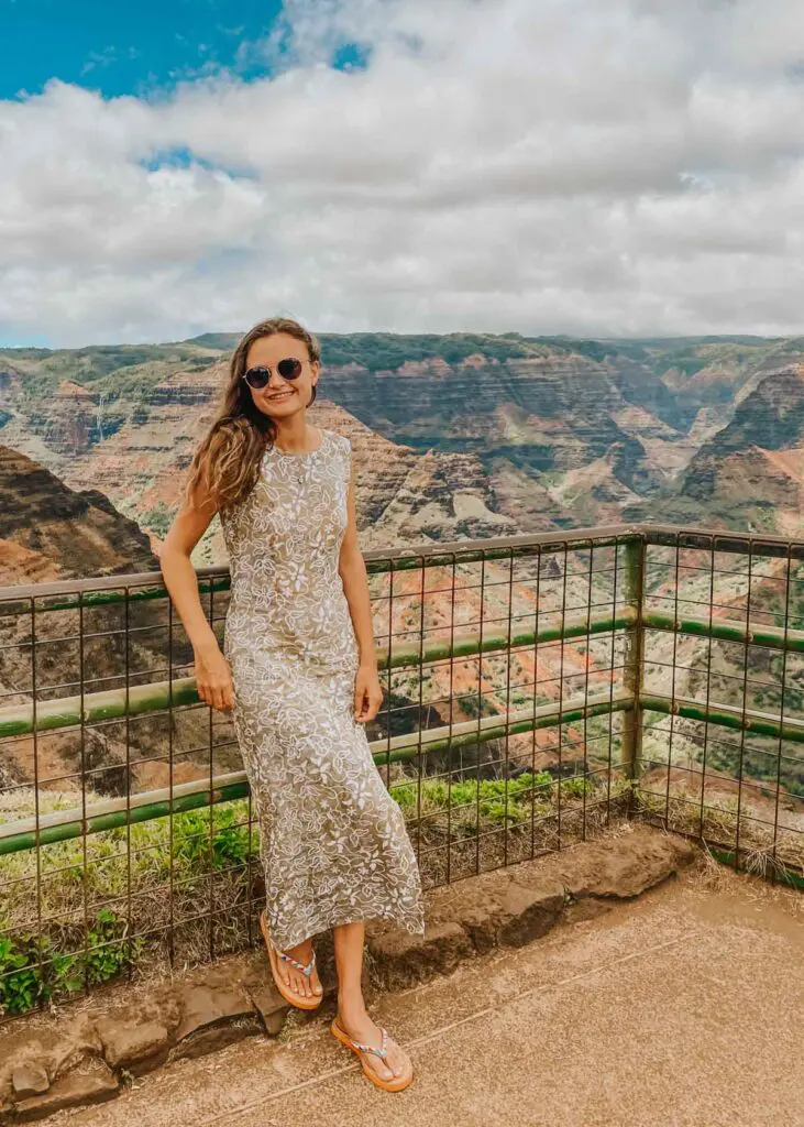 Woman in floral Hawaiian dress at Waimea Canyon on Kauai, Hawaii