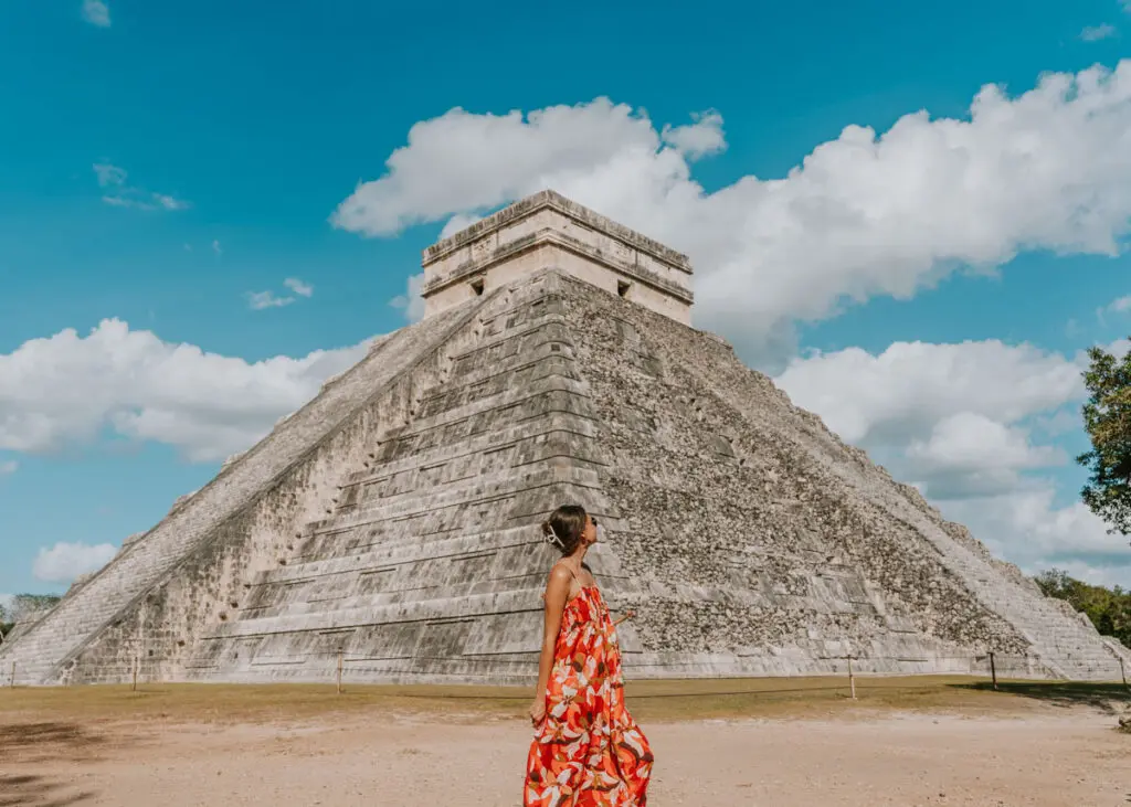 Chichen Itza pyramid with a woman posing in front