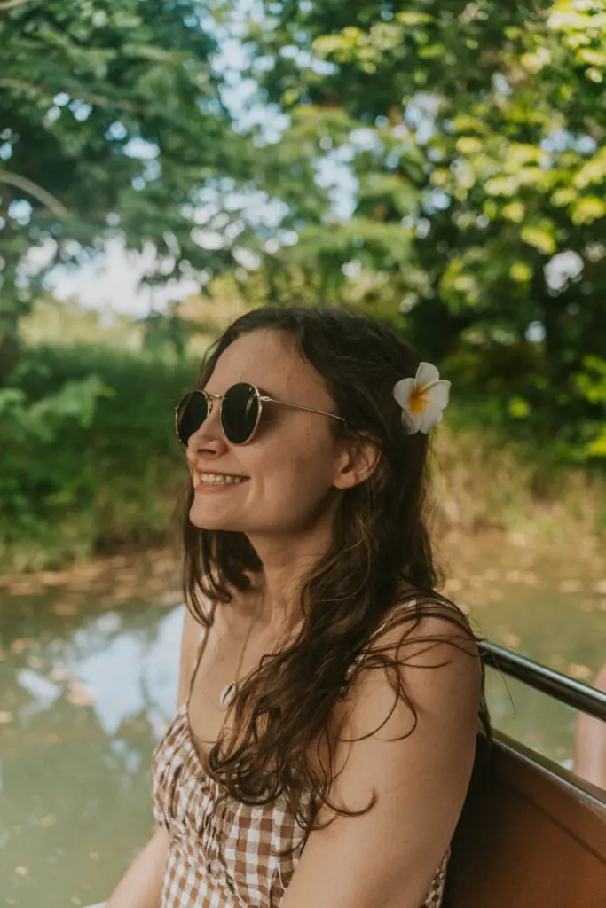Woman with flower in her hair  cruising down Río Espíritu Santo, one of the best things to do in Rio Grande, Puerto Rico