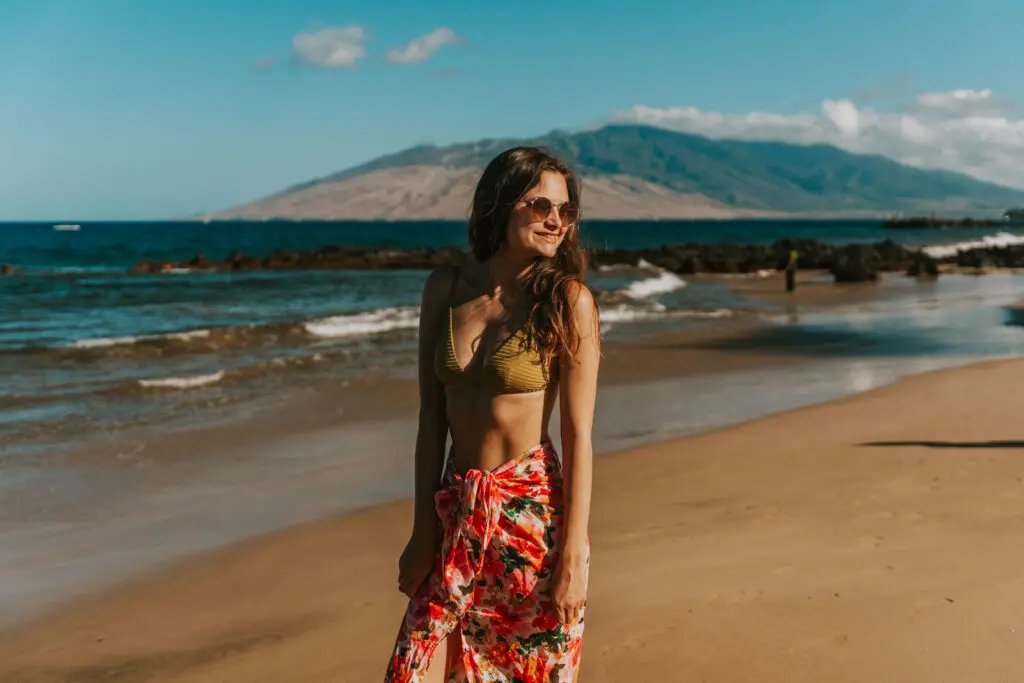 Woman walking along the beach in Maui