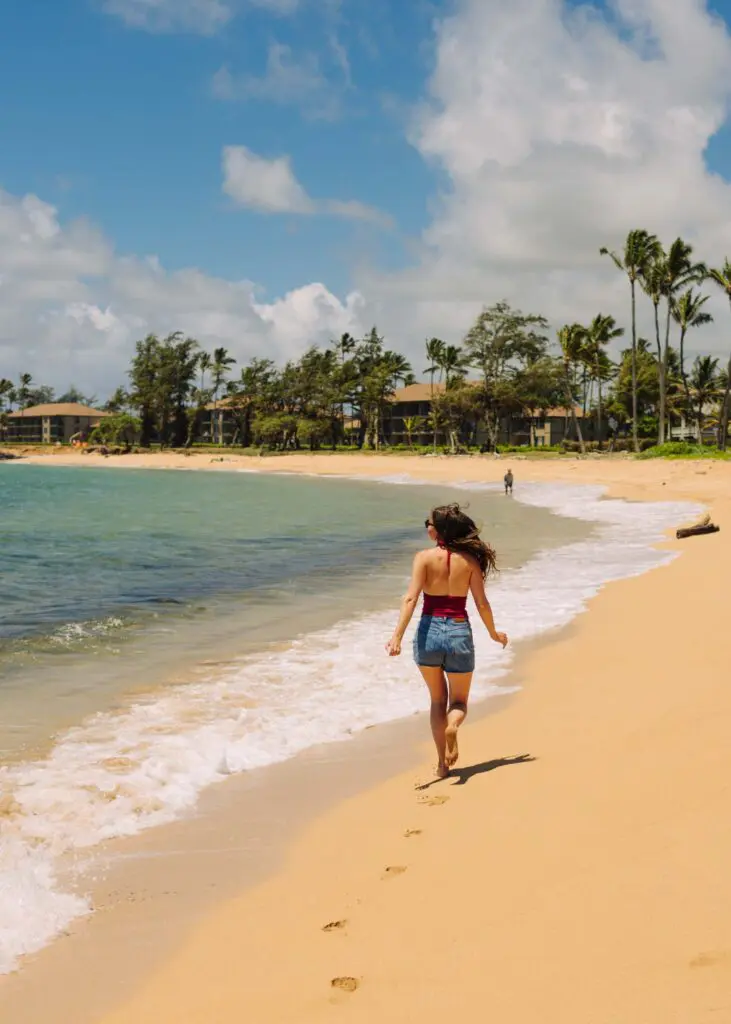 Running along the sand at Kapaa Beach Park in Hawaii