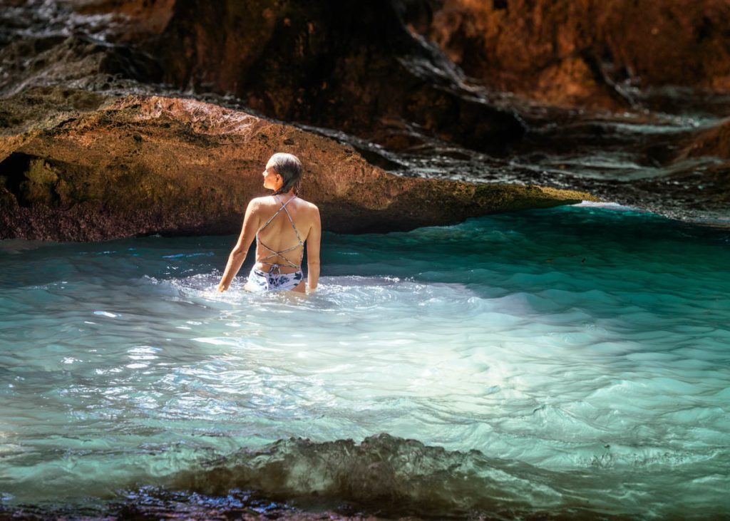 Woman standing in the water in the Mermaid Caves on Oahu