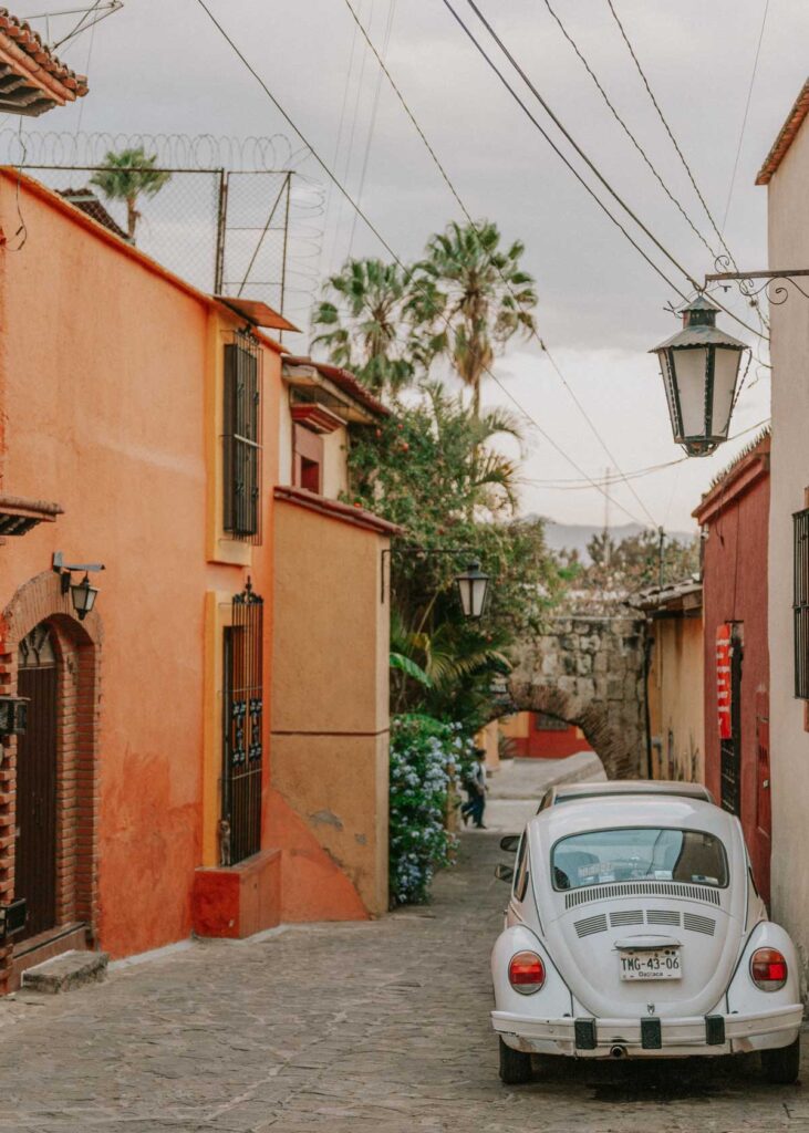 Vintage car parked in alleyway in Oaxaca City