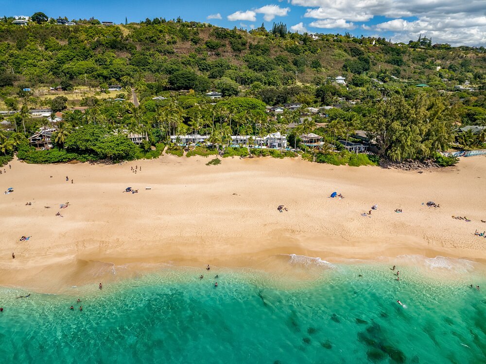 Beautiful sandy beach and bungalows along the shore, one of the best places to stay on the North Shore of Oahu