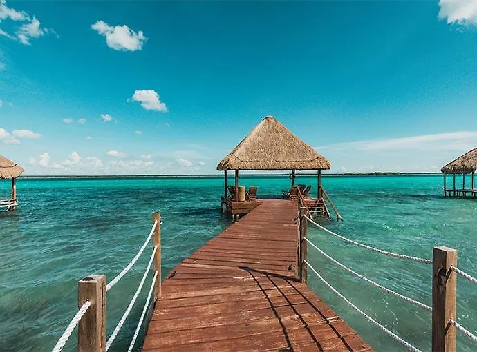Wooden dock extending out into Bacalar lagoon at a Bacalar hotel